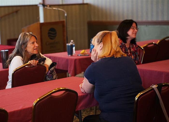 Attendees discuss at the AIU's SEL day.
